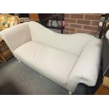 A MODERN UPHOLSTERED SETTEE