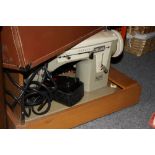 A CASED VINTAGE ALPHA 365 ZIG ZAG SEWING MACHINE