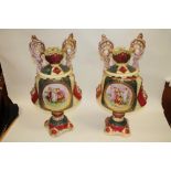 A PAIR OF LARGE VICTORIAN STYLE TWIN HANDLED VASES WITH FIGURATIVE DETAIL SIGNED KAUFMANN