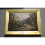 A FRAMED OIL ON CANVAS DEPICTING A WOODED LANDSCAPE WITH FIGURES ON THE ROAD BY G WILLIS PRYCE