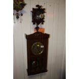 A VINTAGE WALL CLOCK TOGETHER WITH A MODERN CUCKOO CLOCK