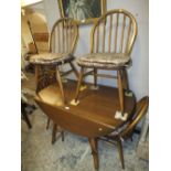AN ERCOL DROPLEAF TABLE AND 4 HOOPBACK CHAIRS