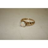 A LADIES 9CT GOLD TWIST BAND RING SET WITH AN OPAL