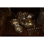 A SILVERPLATED FOUR PIECE TEA SERVICE TOGETHER WITH A TOAST RACK (5)