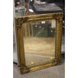 AN ANTIQUE GILT FRAMED MIRROR