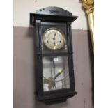 AN EDWARDIAN OAK WALL CLOCK