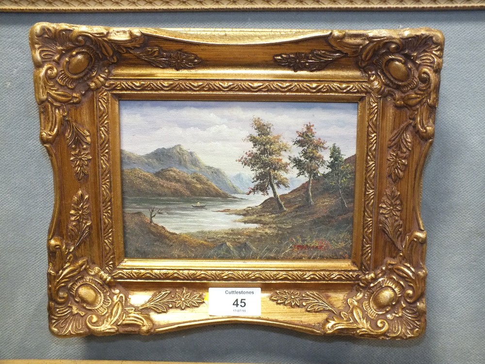 A SMALL GILT FRAMED OIL ON BOARD OF A MOUNTAINOUS LAKE SCENE, INDISTINCTLY SIGNED LOWER RIGHT