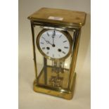 A FRENCH BRASS FOUR GLASS MANTEL CLOCK WITH JAPY FRERES MOVEMENT, white enamel dial with Roman