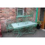 A LARGE ORNATE WIRE WORK STYLE METAL GARDEN TABLE AND SIX CHAIRS