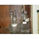 FOUR CUT GLASS DECANTERS