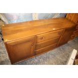 AN ERCOL LOW SIDEBOARD - W 155 CM