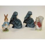 TWO POOLE POTTERY OTTER FIGURES TOGETHER WITH A BESWICK PETER RABBIT AND ANOTHER