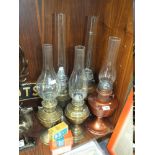 FIVE ASSORTED OIL LAMPS WITH BOXED WICKS ETC