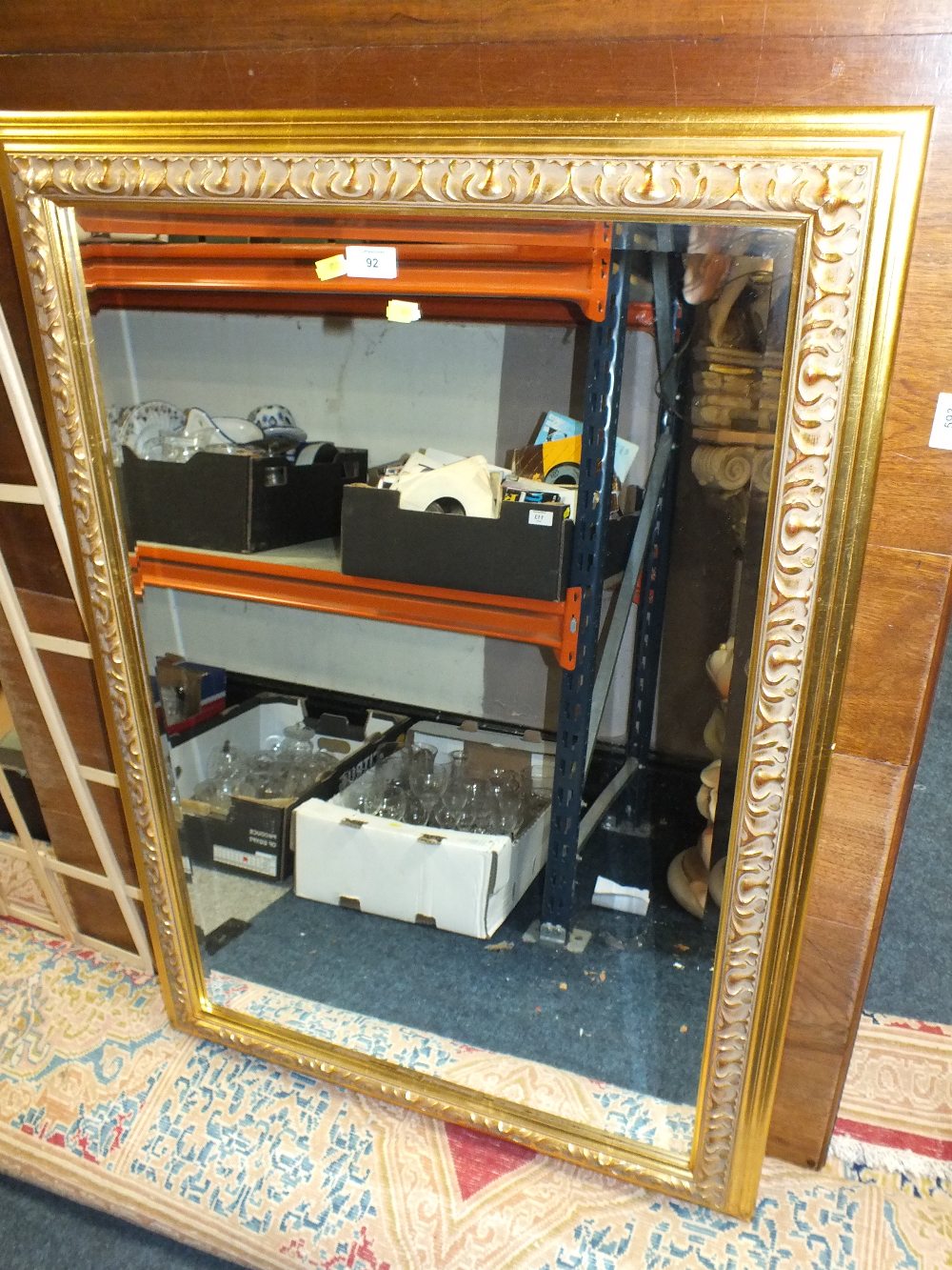 A LARGE MODERN GILT FRAMED BEVEL EDGED MIRROR