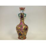 AN ORIENTAL STYLE TWIN HANDLED VASE DECORATED WITH FIVE CLAWED DRAGON DECORATION WITH CHARACTER