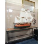 A LARGE HAND BUILT WOODEN SAILING SHIP, IN A PERSPEX CASE ON STAND