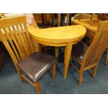 A MODERN SMALL FOLD-OVER DINING TABLE AND TWO CHAIRS