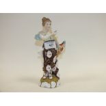 A DRESDEN FIGURE OF A LADY HOLDING CARDS ETC