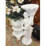 A WHITE FIGURATIVE JARDINIERE STAND WITH A FLOWER