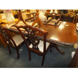 A MAHOGANY EXTENDING TWIN PEDESTAL DINING TABLE AND FOUR CHAIRS L-235 CM W-115 CM