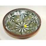 A CERAMIC AND LEATHER BOWL DECORATED WITH FISH AND BIRDS