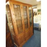 A LARGE 'DUCAL' PINE GLAZED DISPLAY CABINET/BOOKCASE H-188 W-132 CM