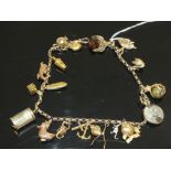 A VINTAGE CHARM BRACELET SET WITH 9CT GOLD CHARMS ETC