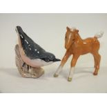 A BESWICK PALOMINO FOAL TOGETHER WITH A BESWICK NUTHATCH