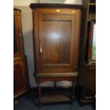 AN ANTIQUE OAK CORNER CUPBOARD ON STAND - H 182 CM