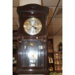 AN OAK HANGING WALL CLOCK