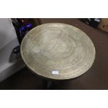 AN ANGLO INDIAN BRASS TOP FOLDING TABLE, the top with Indian script, the base carved with fluted