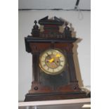 AN OAK MANTLE CLOCK