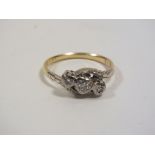 AN 18CT GOLD ILLUSION SET THREE STONE DIAMOND RING WITH HEART SHAPED CENTRAL SETTING