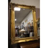 A MODERN HEAVY GILT FRAMED RECTANGULAR WALL MIRROR 82 X 110 CM