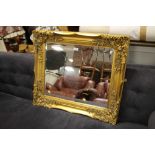 A MODERN HEAVY GILT FRAMED WALL MIRROR 79 X 68 CM