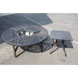 A LARGE CIRCULAR CAST METAL GARDEN TABLE WITH INSET STEEL BOWL WITH A SMALLER EXAMPLE
