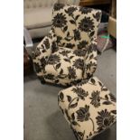 A MODERN UPHOLSTERED ARMCHAIR WITH FOOTSTOOL