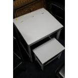 A SMALL WHITE CHILDS DESK AND CHAIR