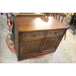 AN OAK 'OAK CHARM' LOW LINENFOLD CABINET W- 92 CM