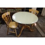 A CIRCULAR KITCHEN TABLE AND TWO CHAIRS