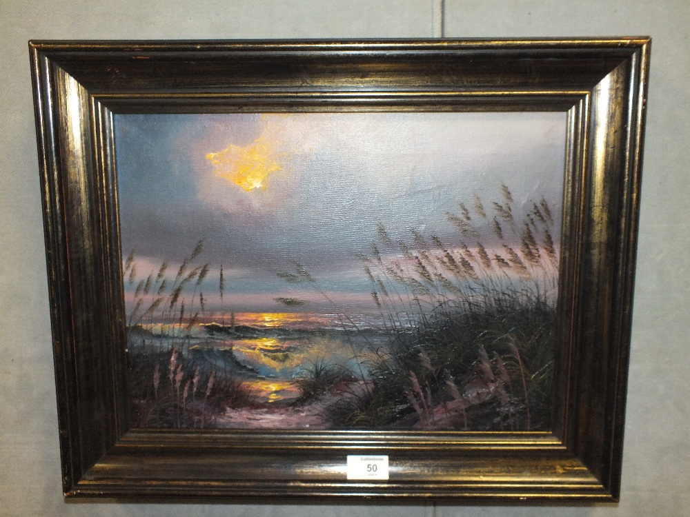 A FRAMED OIL ON CANVAS DEPICTING A BEACH SCENE WITH SUNSET