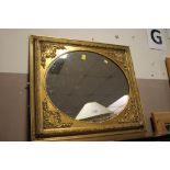 A MODERN GILT FRAMED WALL MIRROR 76 X 66 CM