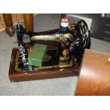 A VINTAGE CASED SINGER SEWING MACHINE