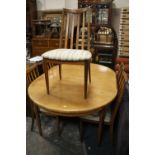 A RETRO TEAK EXTENDING DINING TABLE AND SIX CHAIRS