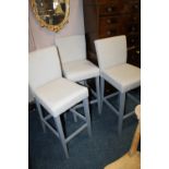 A SET OF THREE MODERN UPHOLSTERED BAR STOOLS