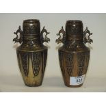 A PAIR OF BRONZE EFFECT TWIN HANDLED VASES