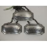 A SET OF THREE HALLMARKED SILVER DECANTER LABELS