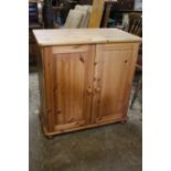 A PINE TWO DOOR CUPBOARD