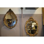 TWO OVAL GILT FRAMED WALL MIRRORS