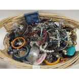 A LARGE BASKET OF COSTUME JEWELLERY